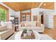 Living room featuring wood ceilings, white furniture, and view to the kitchen area at 270 31St St, Boulder, CO 80305