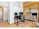 Bright office featuring hardwood floors, built-in cabinets, and a view into the main living space at 270 31St St, Boulder, CO 80305