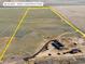 Aerial view showcases this new construction home on 36 acres with a yellow perimeter line at 61800 E 32Nd Ct, Strasburg, CO 80136