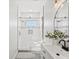 Bright bathroom boasts shower with glass door, white subway tile, modern vanity with black faucet at 61800 E 32Nd Ct, Strasburg, CO 80136