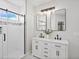 Modern bathroom featuring a double vanity, sleek black fixtures, and a glass-enclosed shower for a spa-like experience at 61800 E 32Nd Ct, Strasburg, CO 80136