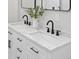 Close-up of a bathroom vanity with modern faucets, a luxurious countertop, and a stylish vase with greenery at 61800 E 32Nd Ct, Strasburg, CO 80136