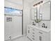 Modern bathroom featuring a double vanity, sleek black fixtures, and a glass-enclosed shower for a spa-like experience at 61800 E 32Nd Ct, Strasburg, CO 80136