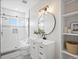 The bathroom has a modern design, vanity, lighting, and white subway tile in the shower at 61800 E 32Nd Ct, Strasburg, CO 80136
