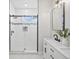 Modern bathroom featuring a double vanity, sleek black fixtures, and a glass-enclosed shower for a spa-like experience at 61800 E 32Nd Ct, Strasburg, CO 80136
