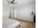 This bedroom features wood floors, white walls, and a minimalist design, creating a serene and modern space at 61800 E 32Nd Ct, Strasburg, CO 80136