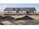 New construction exterior showing rock detail and modern, black trimmed windows at 61800 E 32Nd Ct, Strasburg, CO 80136