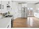 Well-lit kitchen with stainless steel appliances, bright white cabinetry, and light colored flooring at 61800 E 32Nd Ct, Strasburg, CO 80136