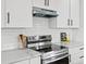Close-up view of a modern kitchen featuring stainless steel appliances, and white cabinets at 61800 E 32Nd Ct, Strasburg, CO 80136