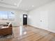 Bright living room with large windows, hardwood flooring, and a comfortable sofa at 61800 E 32Nd Ct, Strasburg, CO 80136