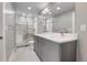 Modern bathroom features a glass enclosed shower and double vanity sinks with white quartz countertops at 2724 Federal Blvd # 2, Denver, CO 80211