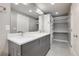 Well-lit bathroom featuring double sinks, storage cabinets, large mirror, and an open closet at 2724 Federal Blvd # 2, Denver, CO 80211