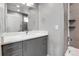 Modern bathroom with gray vanity, white countertop and large mirror at 2724 Federal Blvd # 2, Denver, CO 80211