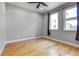 Bright bedroom features hardwood floors, two windows, modern ceiling fan and grey painted walls at 2724 Federal Blvd # 2, Denver, CO 80211