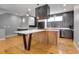 Open kitchen features gray and white cabinets, modern appliances and a large island with seating at 2724 Federal Blvd # 2, Denver, CO 80211