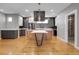 Open kitchen features gray and white cabinets, modern appliances and a large island with seating at 2724 Federal Blvd # 2, Denver, CO 80211