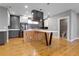 Open kitchen features gray and white cabinets, modern appliances and a large island with seating at 2724 Federal Blvd # 2, Denver, CO 80211