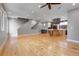 Open concept living area with hardwood floors seamlessly transitioning to the kitchen at 2724 Federal Blvd # 2, Denver, CO 80211