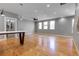 Bright living room with light hardwood floors, gray walls, recessed lights and many windows at 2724 Federal Blvd # 2, Denver, CO 80211