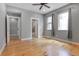 Spacious main bedroom with hardwood floors, two windows, and attached bathroom at 2724 Federal Blvd # 2, Denver, CO 80211