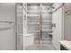 Modern shower with white tiling, grey accent wall and a built in bench offers an inviting and luxurious space at 2724 Federal Blvd # 2, Denver, CO 80211