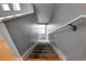 Carpeted stairway with wooden railing and gray walls leading to the upper level at 2724 Federal Blvd # 2, Denver, CO 80211