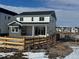 Two-story home with white siding, gray accents, and fenced backyard at 16538 W 92Nd Ave, Arvada, CO 80007