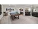 Expansive basement with a pool table, seating at bar, and open layout for entertaining at 8815 S Tibet Ct, Aurora, CO 80016