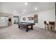 Spacious finished basement with a pool table, bar stools, and ample room for entertainment at 8815 S Tibet Ct, Aurora, CO 80016