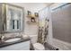 Bright bathroom with modern vanity, tub shower with decorative curtain, and stylish decor at 8815 S Tibet Ct, Aurora, CO 80016