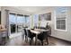 Elegant dining room with a sliding door, backyard views, and stylish decor at 8815 S Tibet Ct, Aurora, CO 80016