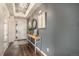 Welcoming foyer with hardwood floors, elegant lighting, a console table, and a view of the front door at 8815 S Tibet Ct, Aurora, CO 80016