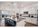 Modern kitchen with a large island, stainless steel appliances, and a view of the dining area at 8815 S Tibet Ct, Aurora, CO 80016