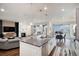 Open-concept kitchen with island seating, stainless appliances, and seamless flow to the living and dining areas at 8815 S Tibet Ct, Aurora, CO 80016
