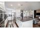 Stylish kitchen with an island, stainless appliances, and an open layout connecting to the living area at 8815 S Tibet Ct, Aurora, CO 80016