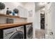 Well-lit laundry room features a wood countertop, shelving, and appliances, creating a functional space at 8815 S Tibet Ct, Aurora, CO 80016