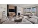 Cozy living room with a fireplace, modern furnishings, a large sectional sofa, and ample natural light at 8815 S Tibet Ct, Aurora, CO 80016