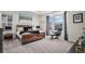 Bright, relaxing main bedroom with a wooden bed frame, a cozy chair, and a large window at 8815 S Tibet Ct, Aurora, CO 80016