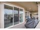 Outdoor patio with dining and seating areas featuring large sliding glass doors to the indoor space at 8815 S Tibet Ct, Aurora, CO 80016