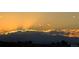 Scenic view of a vibrant sunset over distant mountains, showcasing the natural beauty of the surrounding landscape at 8815 S Tibet Ct, Aurora, CO 80016