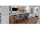 Elegant wet bar featuring stone accents, granite countertops, seating, and stylish fixtures at 8815 S Tibet Ct, Aurora, CO 80016