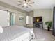 Spacious main bedroom with a modern ceiling fan, a decorative barn door, and ample natural light at 9595 S Everett Way, Littleton, CO 80127