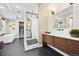 Bright bathroom featuring a glass enclosed shower, tub, modern vanity, and stylish fixtures at 9006 E 60Th Ave, Denver, CO 80238