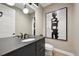 Modern bathroom features a vanity with double sinks, sleek fixtures, and contemporary decor at 9006 E 60Th Ave, Denver, CO 80238