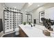 Modern bathroom featuring a stylish tile shower, sleek vanity, and contemporary fixtures at 9006 E 60Th Ave, Denver, CO 80238