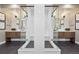 Modern bathroom featuring dual glass-enclosed showers, vanities and contemporary finishes at 9006 E 60Th Ave, Denver, CO 80238