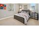 Comfortable bedroom with stylish bed frame, decorative bedside tables, and natural light at 9006 E 60Th Ave, Denver, CO 80238