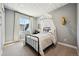 Charming bedroom featuring a canopy bed, soft colors, and bright natural light at 9006 E 60Th Ave, Denver, CO 80238