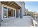 A large covered patio with stone pillars and access to the interior of the house at 9006 E 60Th Ave, Denver, CO 80238