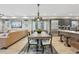 Inviting dining area connects to the kitchen, featuring an elegant table set, hardwood floors, and stainless appliances at 9006 E 60Th Ave, Denver, CO 80238